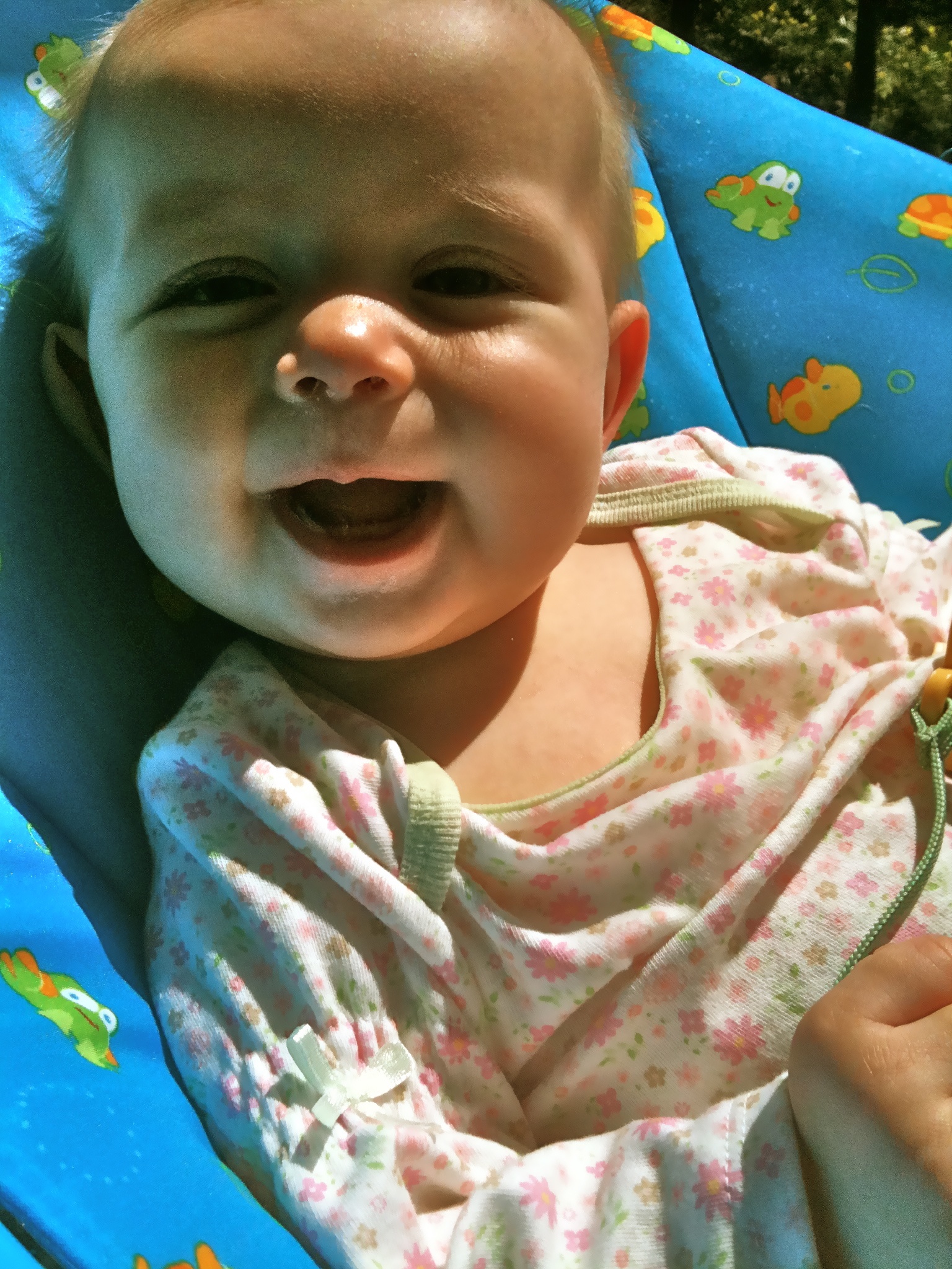 a baby lays in a pool seat