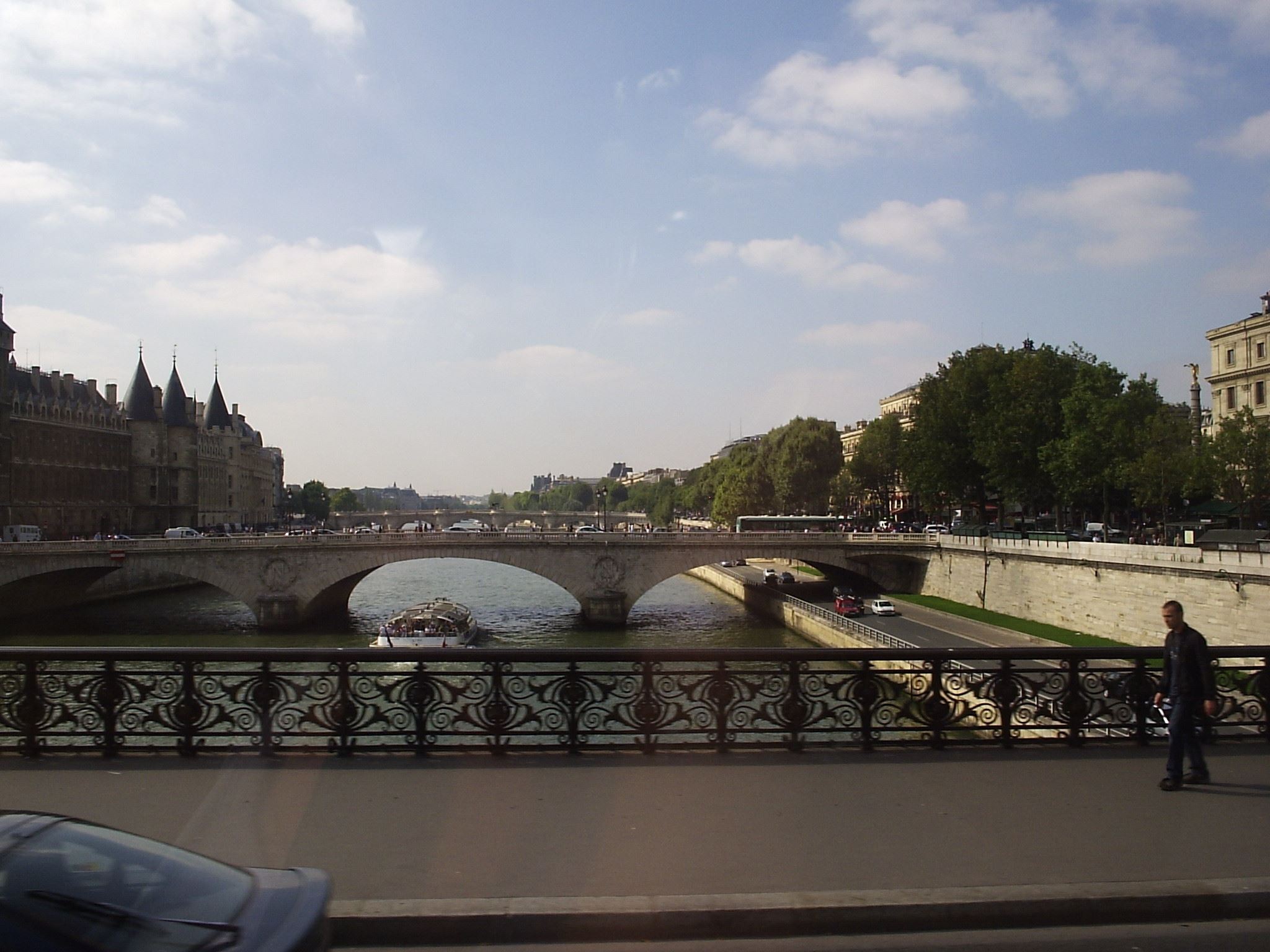 a person standing on the side of a bridge over a river