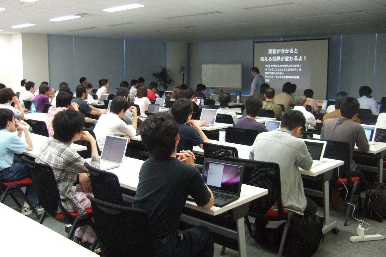 a classroom with students using their laptops during class