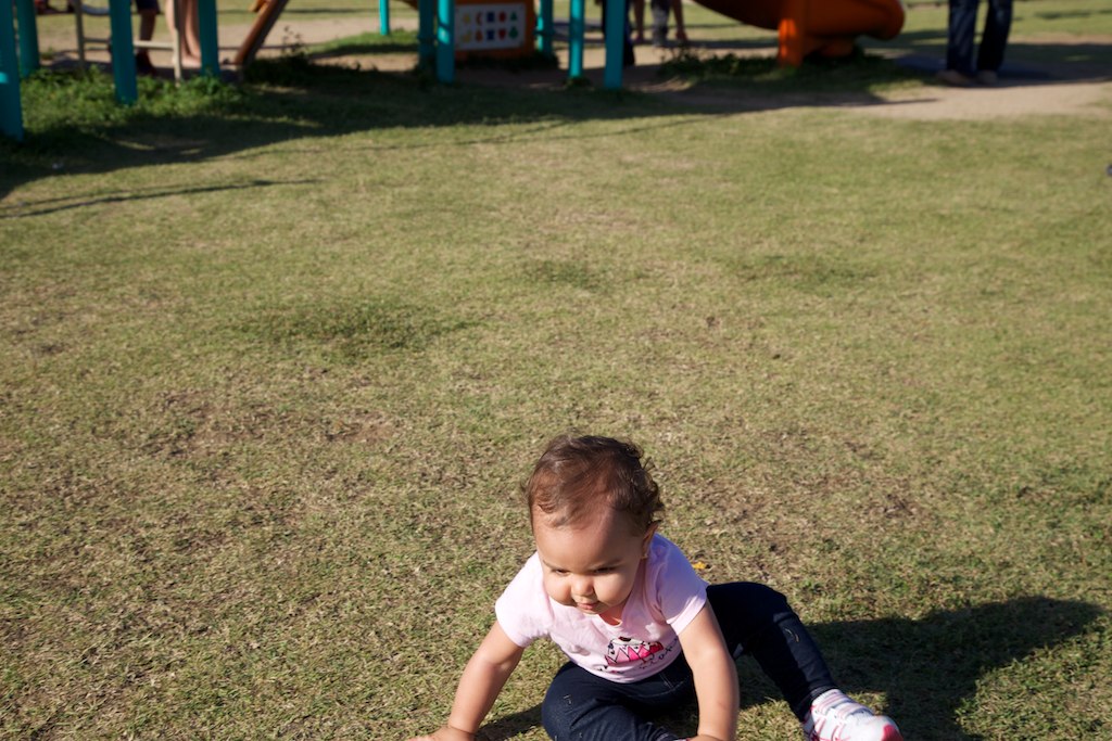 a child sitting on the ground on a playground