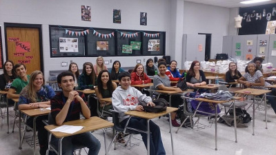 a classroom full of students sitting at desks