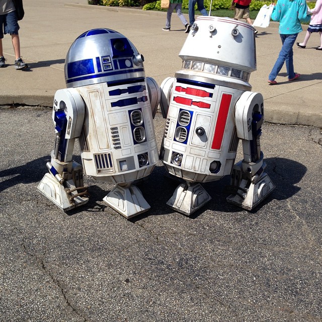 two toy droids that are on the street