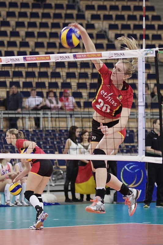 the volleyball player jumps to hit the ball