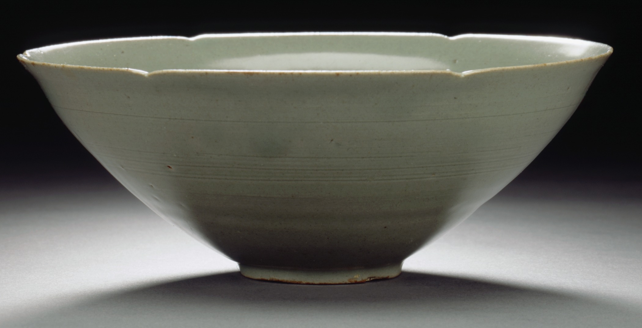 a white bowl is sitting on a table