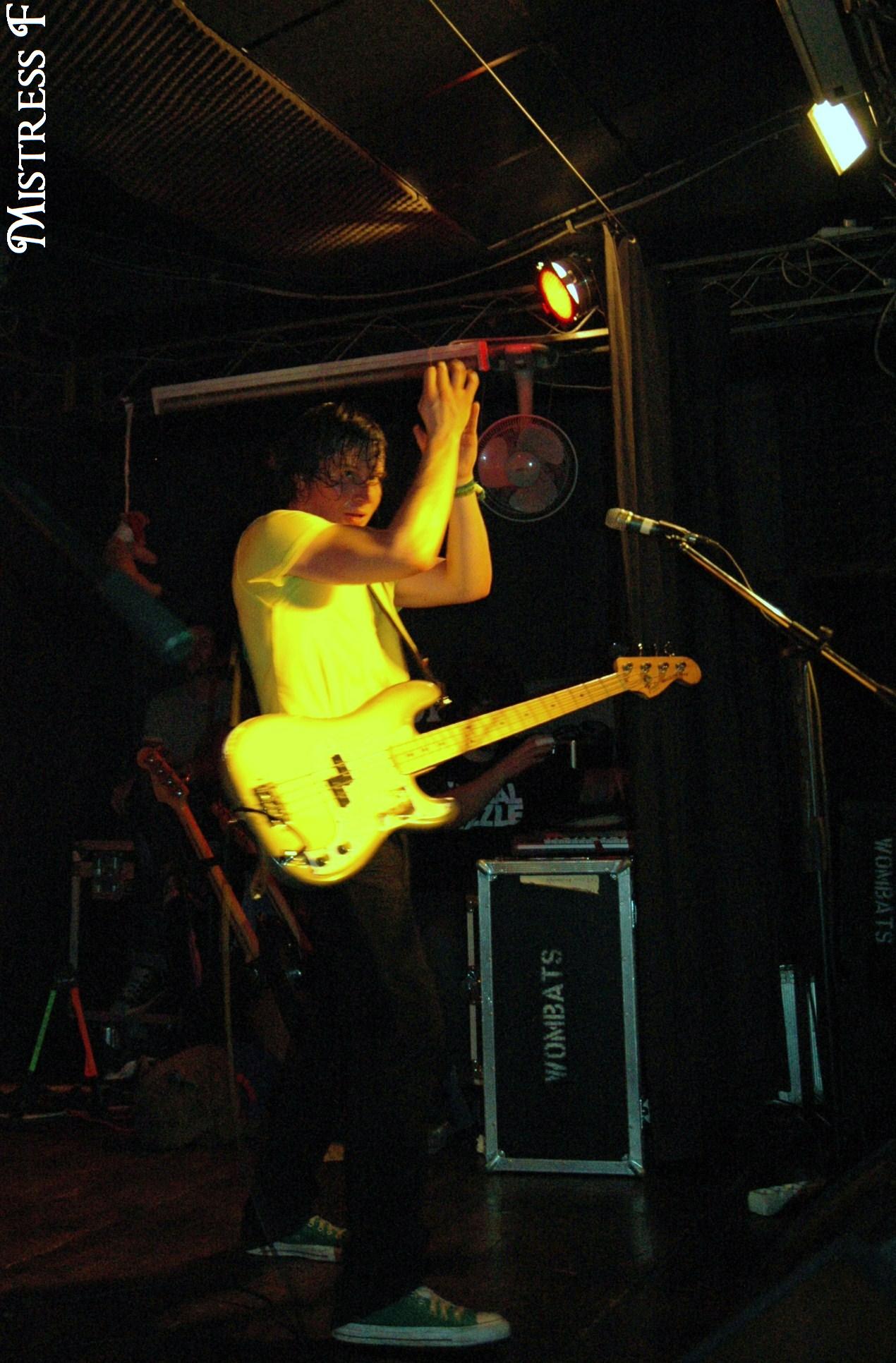 a man playing guitar with a microphone