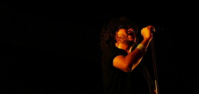 a man holding a microphone in his right hand
