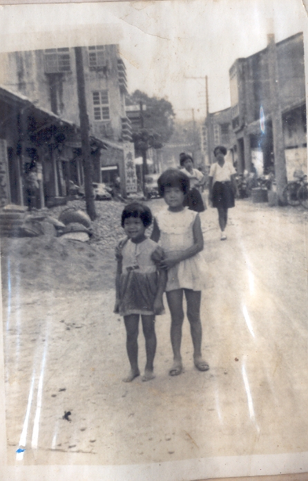 a black and white image of children in an old town