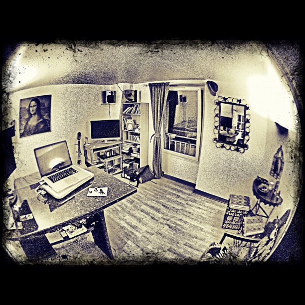 a room with wooden floors and a laptop computer