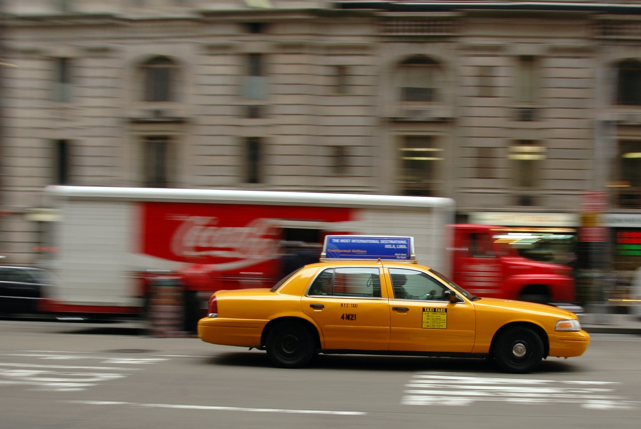 a taxi cab is moving down the street
