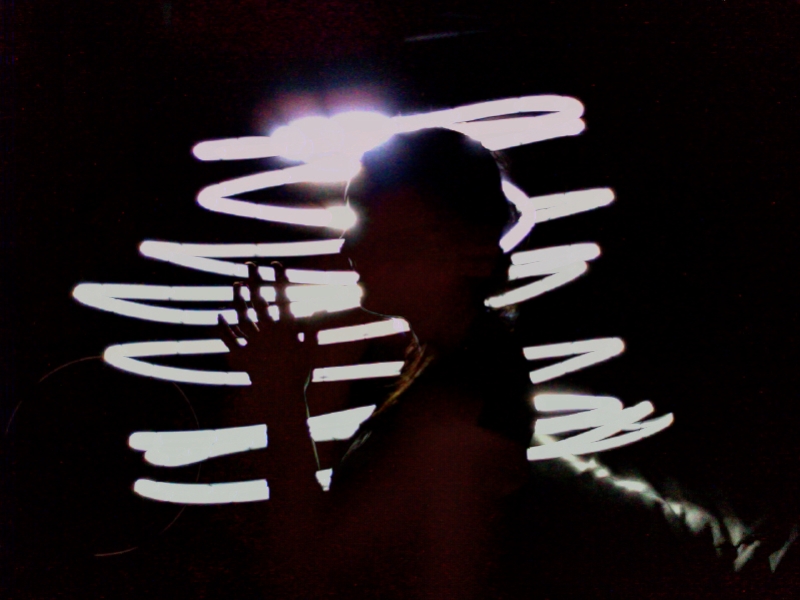 a man standing in front of a light display