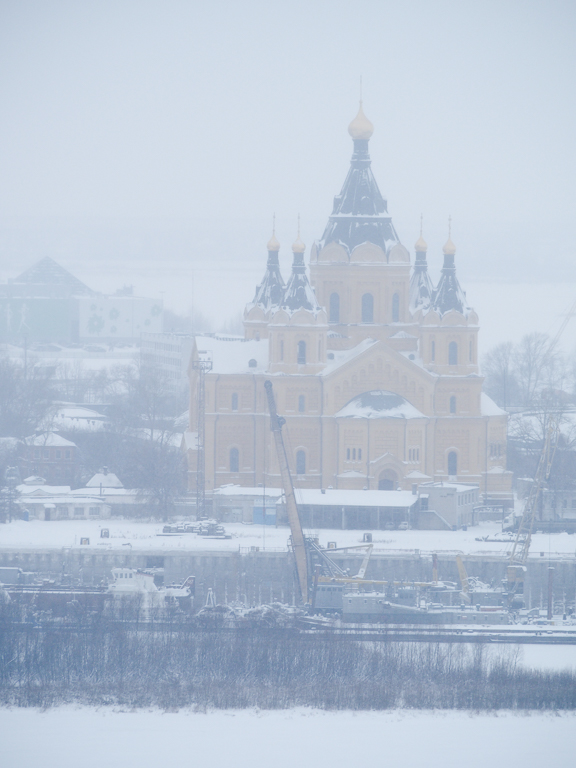 an old building sitting in the snow on top of a hill