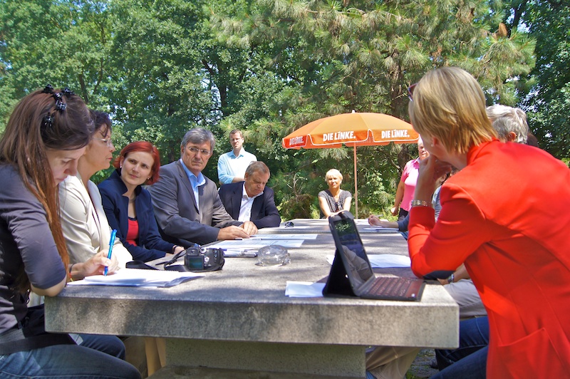 a group of people sitting around a cement table