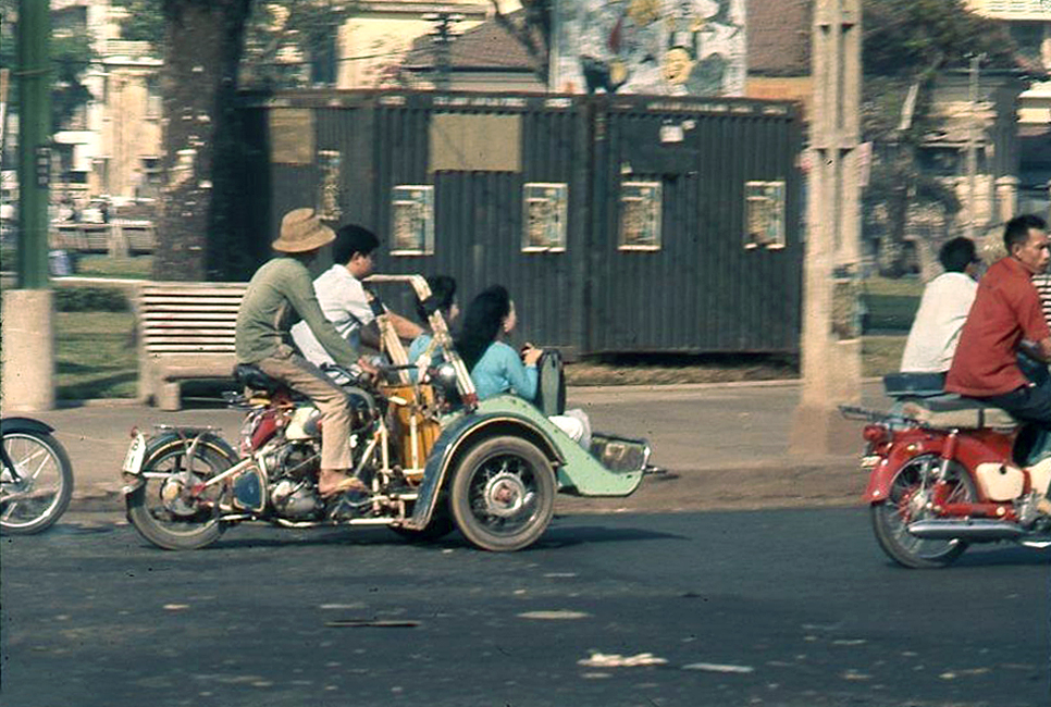 a group of bikers ride around a city street