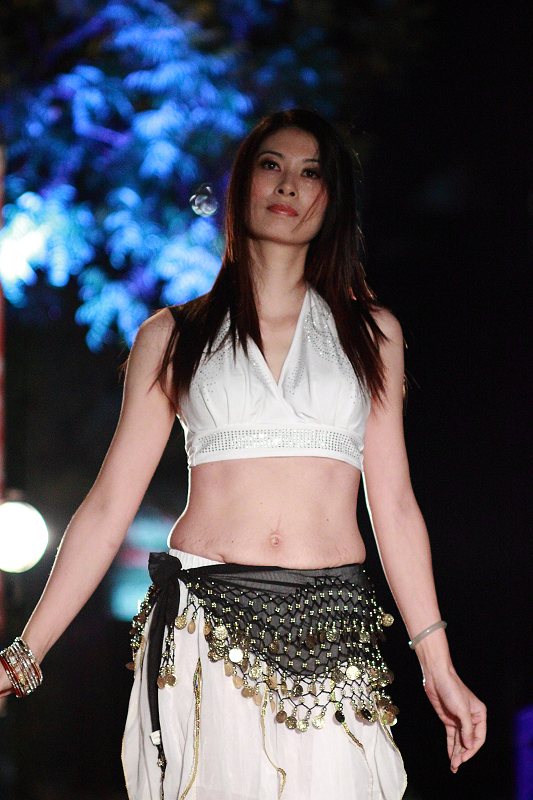 a woman walking down a runway with  on