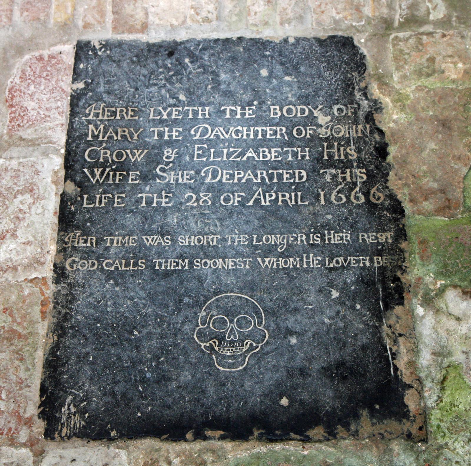 a tombstone marker on the side of a building