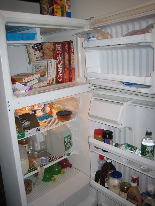 an open refrigerator is showing some food and drinks