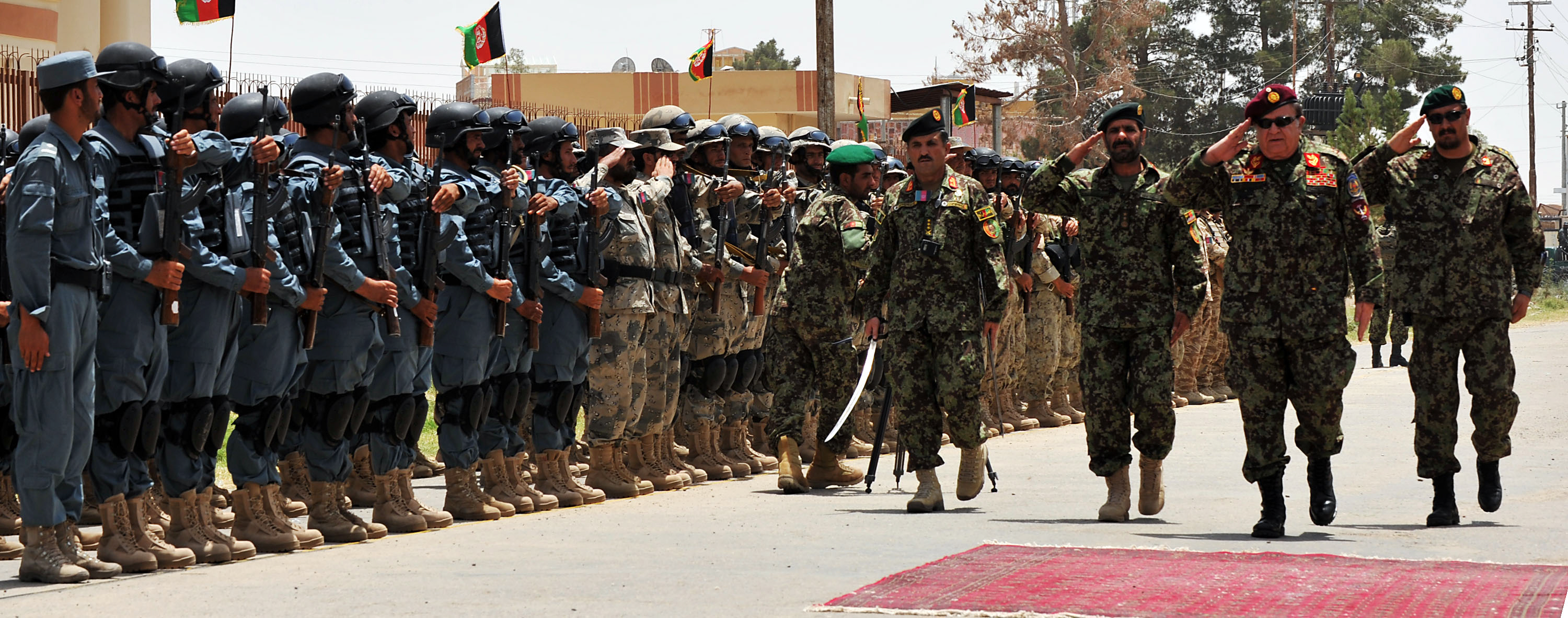 men wearing uniforms are standing together as one points his gun at another person