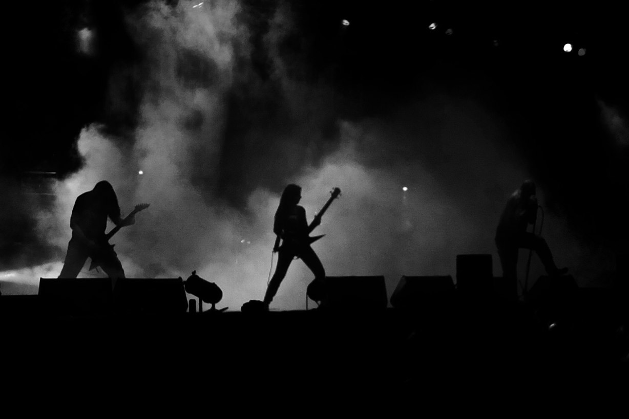 two men that are holding some guitars on a stage