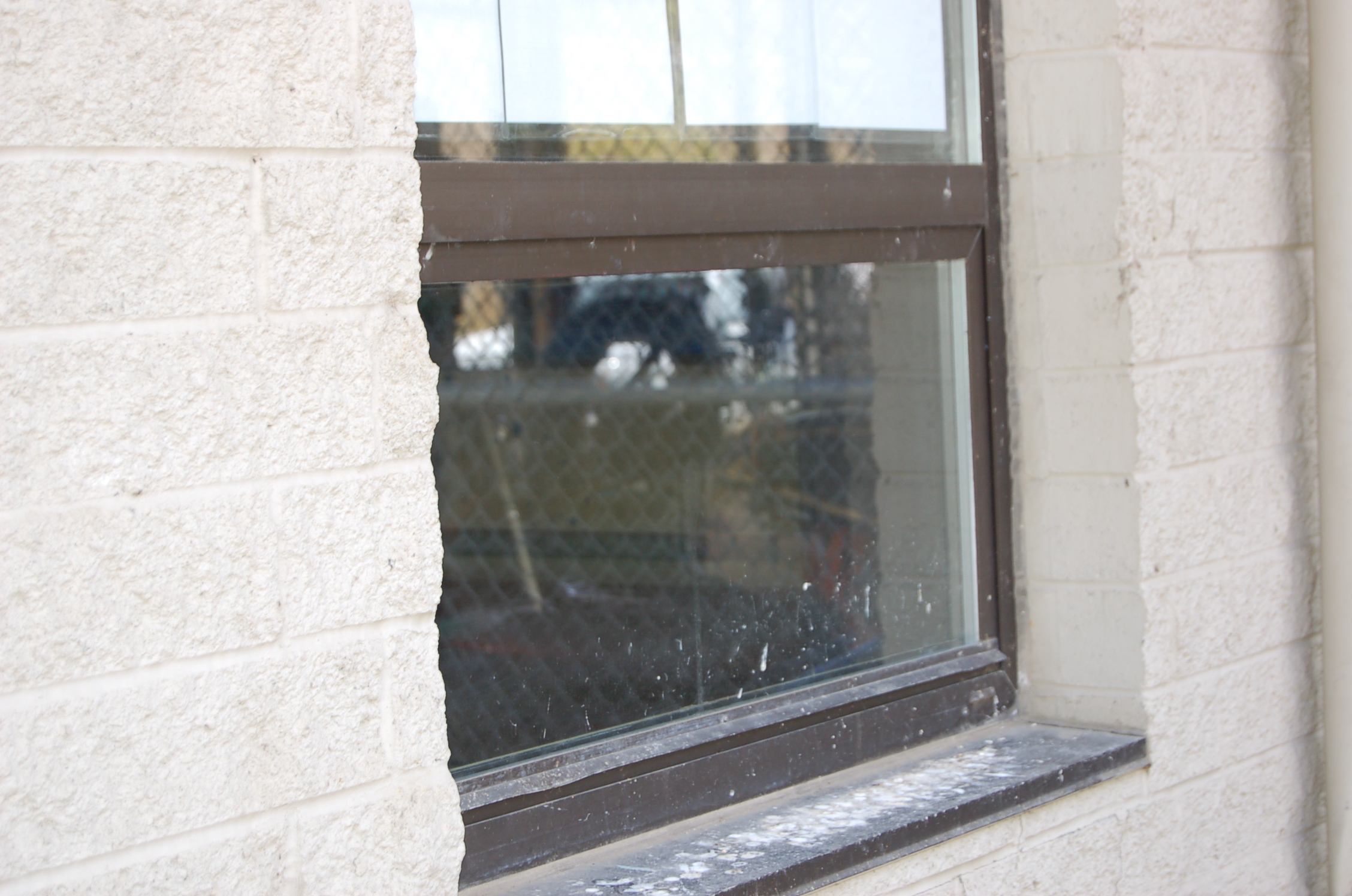 a window on the side of a building that is torn off