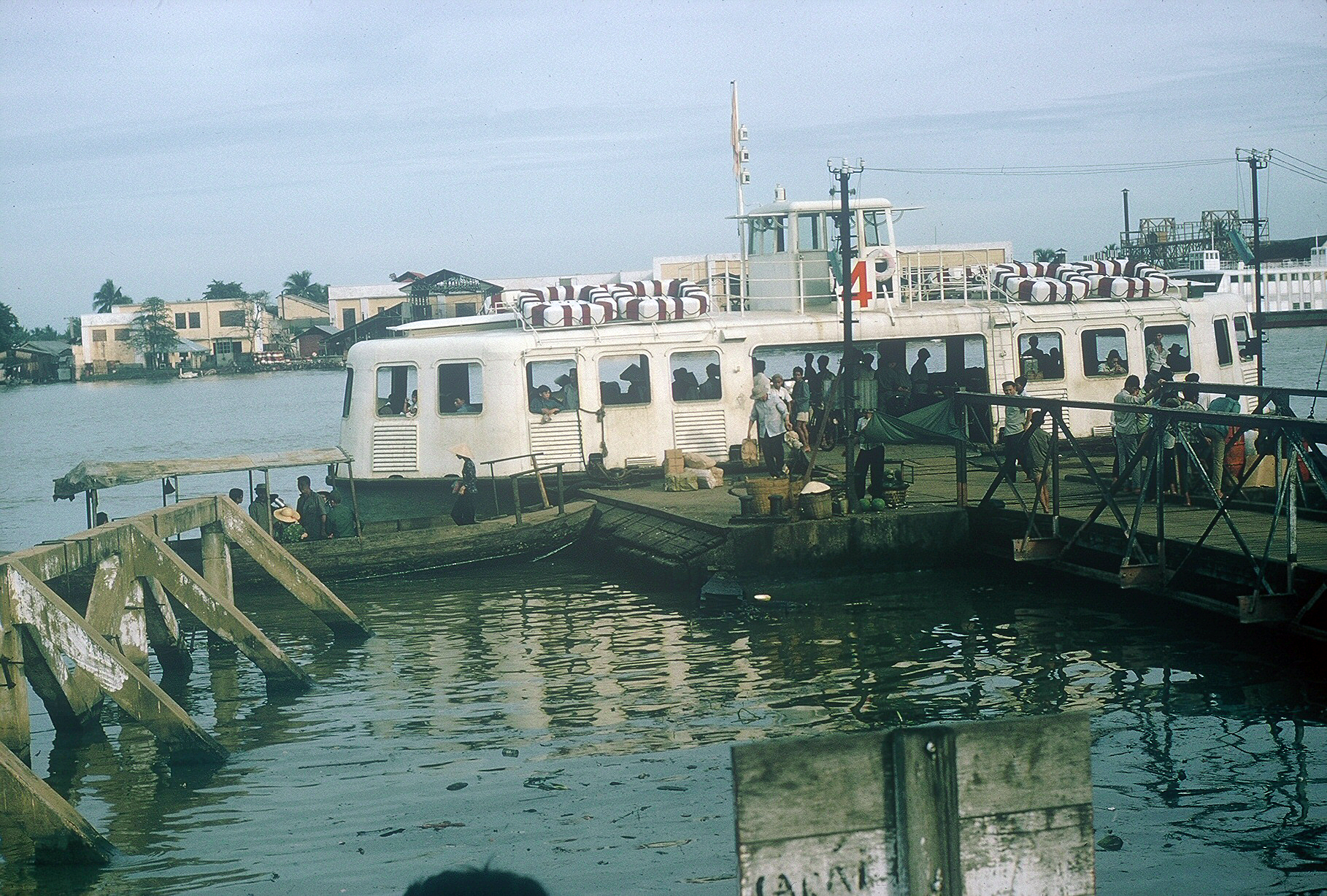 two people looking at a ship near some water