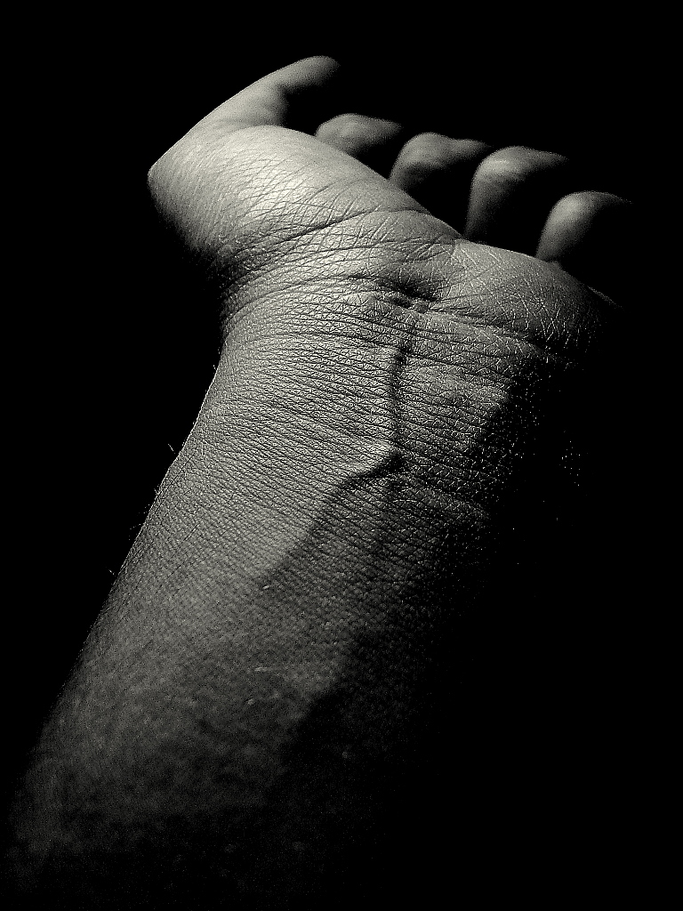 an artistic pograph of the back end of a couch in a dark room