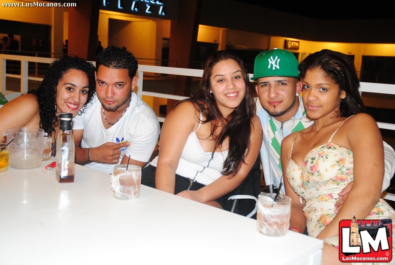 a group of young people are sitting at a table