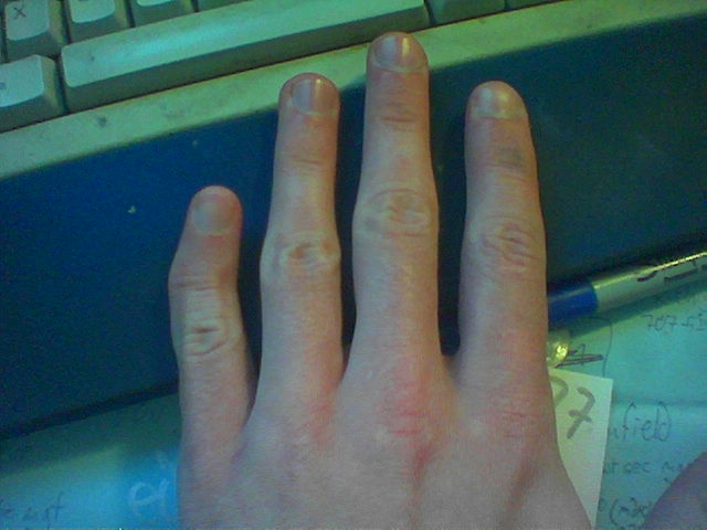 a close up of a person with nails on their hands near a keyboard