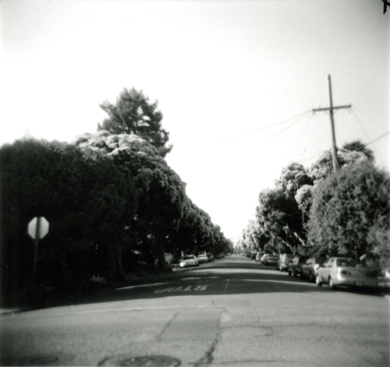 a long road that leads to an intersection with traffic