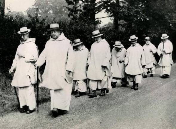 a group of old men walking down a road