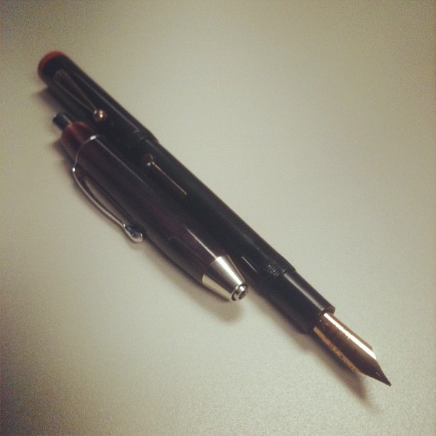 a pen sitting on a table with its end open