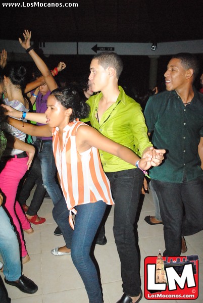a woman and man dancing at a party