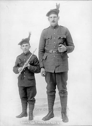 two soldiers with instruments pose for a po