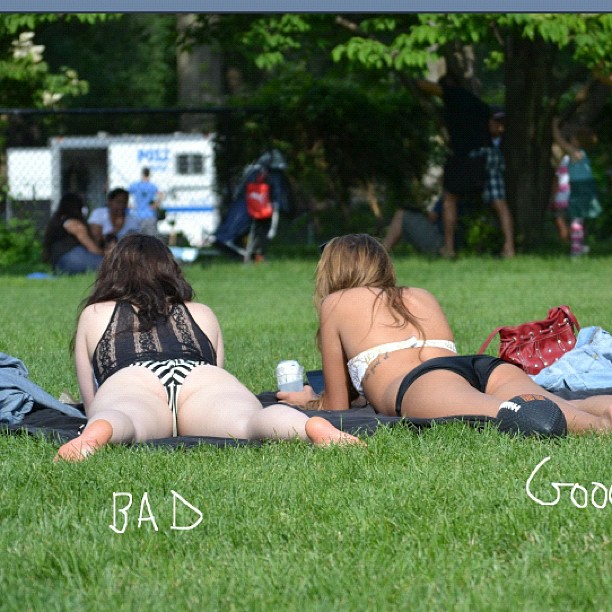 two girls laying on the grass while wearing panties