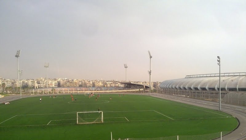 an empty soccer field in the middle of a city