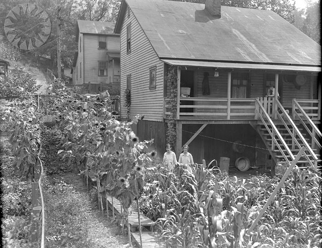 people and flowers in front of a wooden building