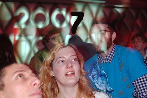 young people in a club with one woman looking at the camera