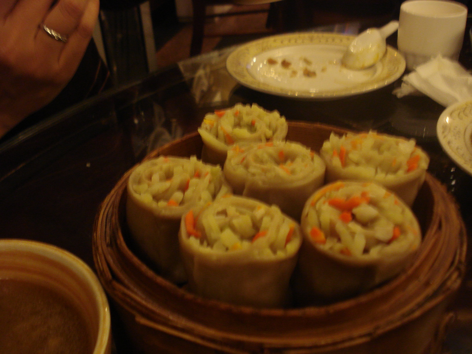 several small containers full of food and plates with food on them