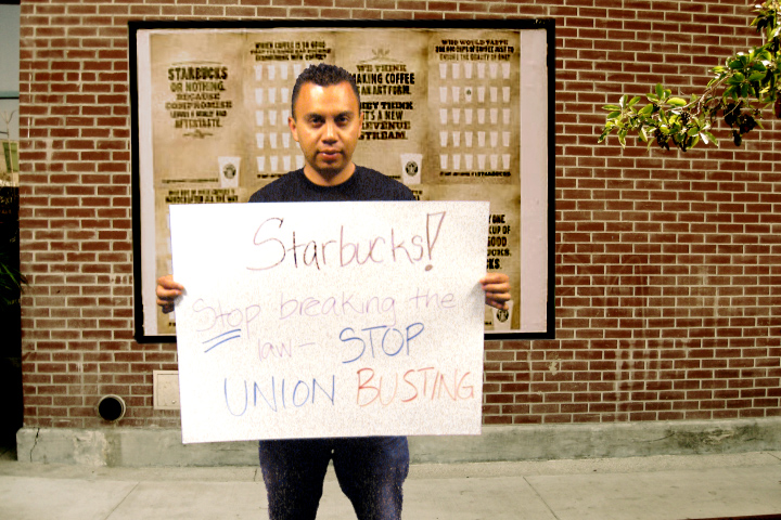 a man holding a sign in front of a building