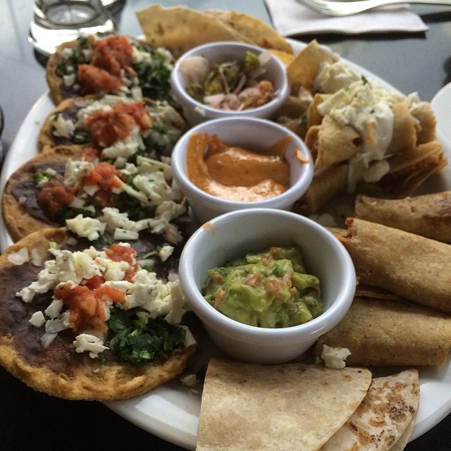 an assortment of mexican foods arranged on a plate