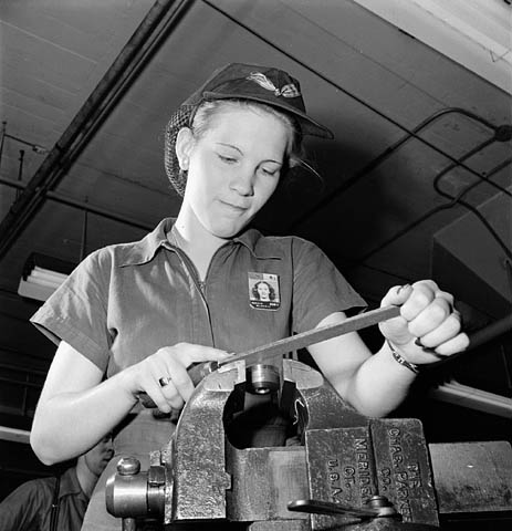 black and white pograph of a woman working on a machine