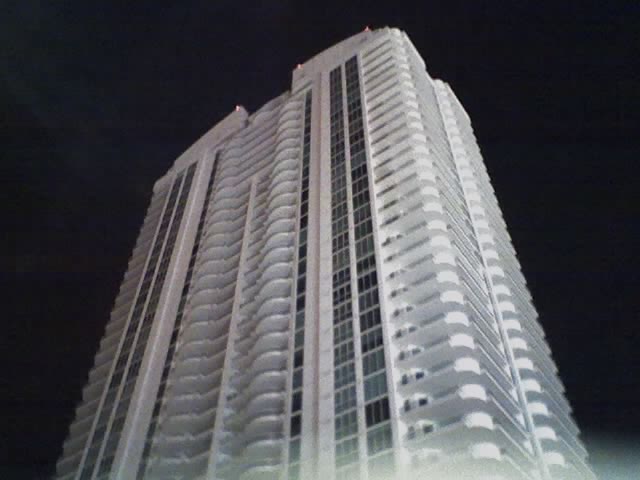 high rise building at night with the lights on