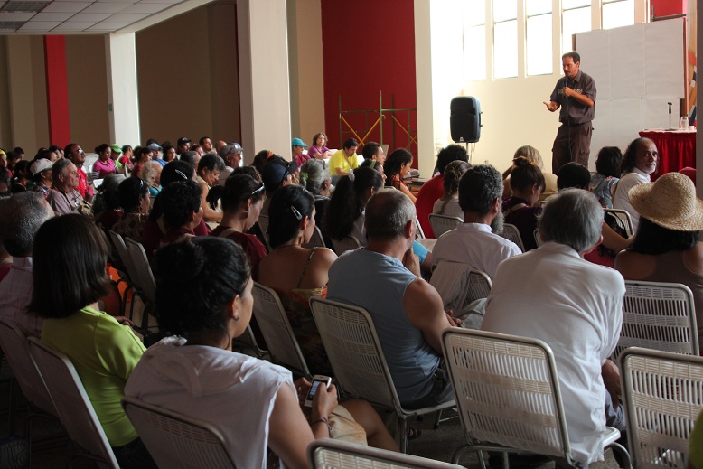 there is a man giving a presentation in front of a large audience