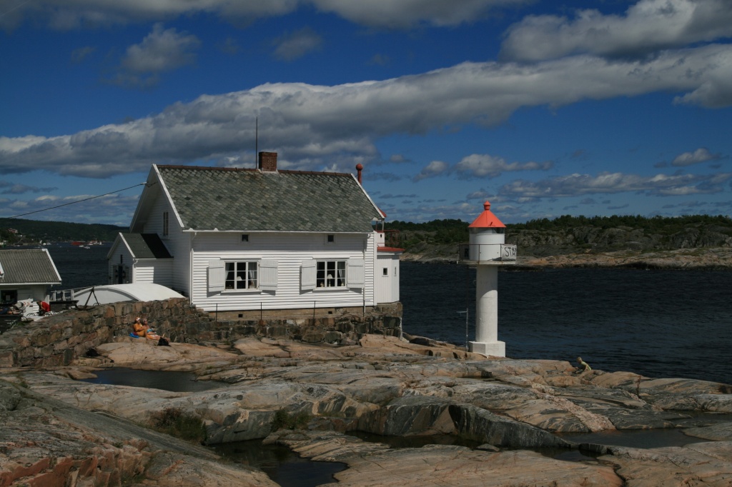 a boat dock with house by the water