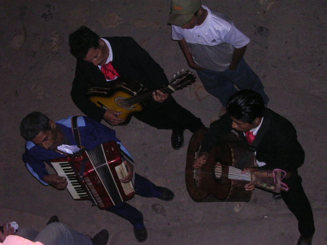 a group of people with guitar in an area