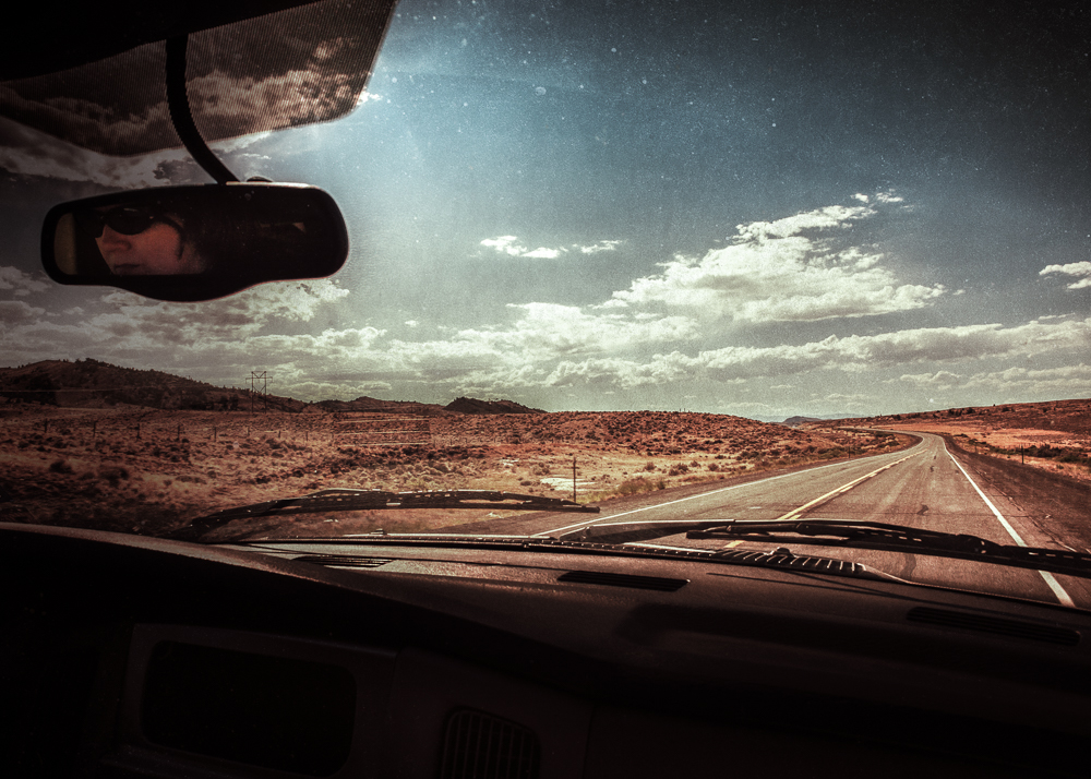 a view from a vehicle driving in the desert