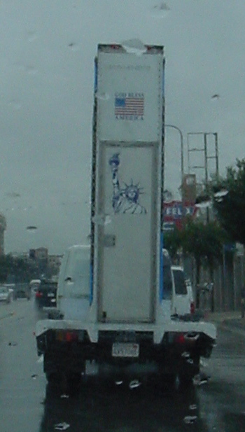 the truck is carrying the american flag on its back