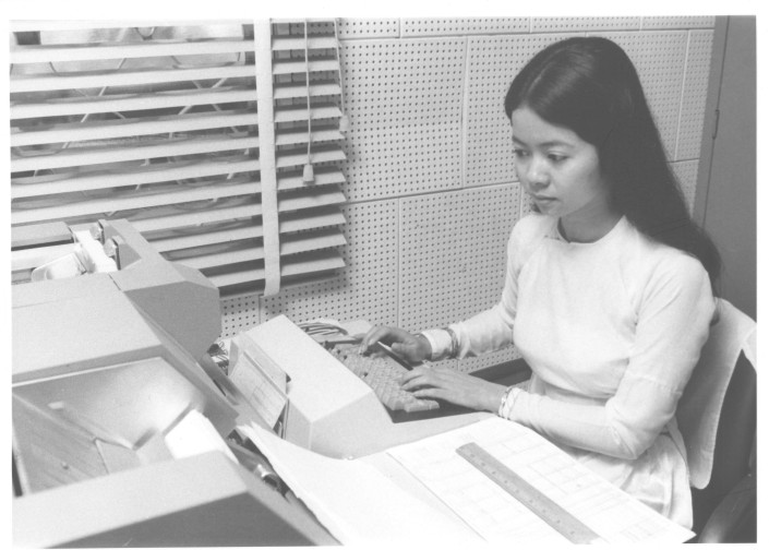 the woman is typing on a piece of paper