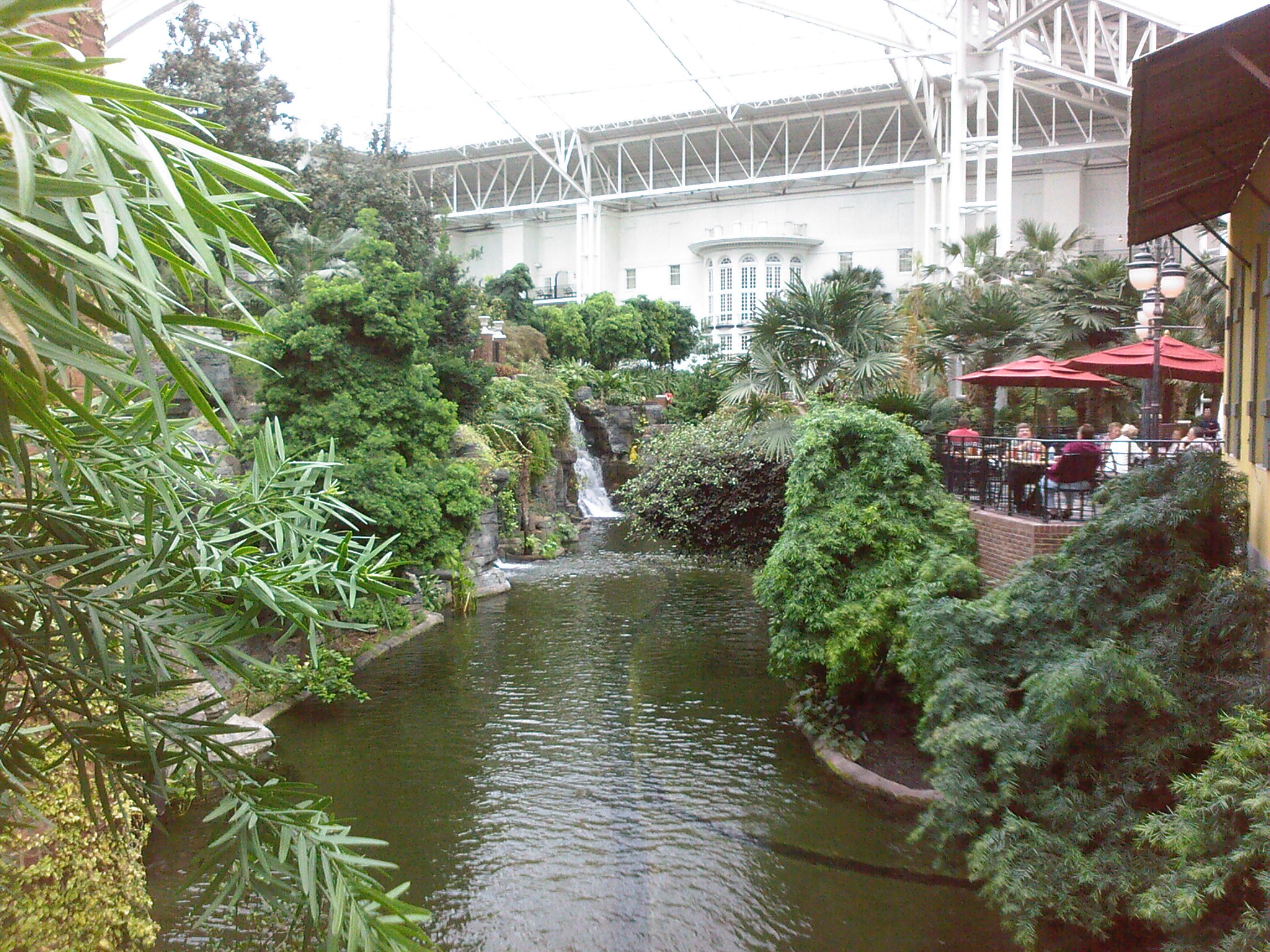 a view looking down a small canal in a garden