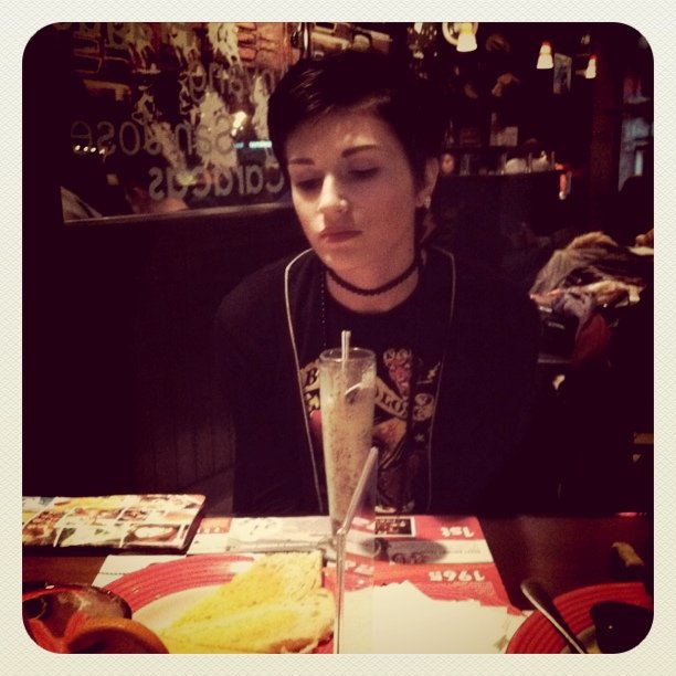 a woman sitting at a table with food in front of her