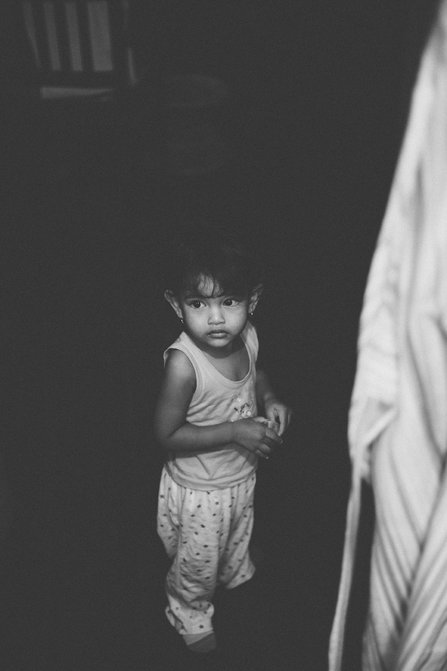 a little girl is standing by some doors